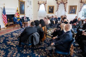 People sitting in a room listening to Wes Moore.