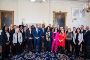 A group of people in a large room smiling for a photo.