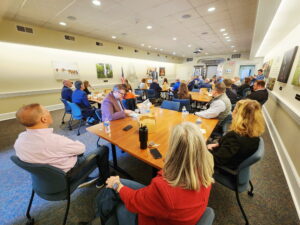 A large group of people sitting in a room.