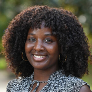 stephora-alberi A young woman with dark brown hair smiling.