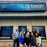 Todd Justice (center-back) owner of Atlantic Technology Services celebrating their 20th anniversary
