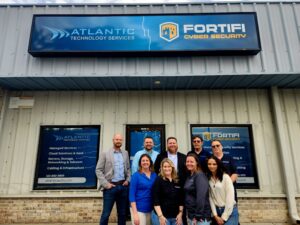 Todd Justice (center-back) owner of Atlantic Technology Services celebrating their 20th anniversary
